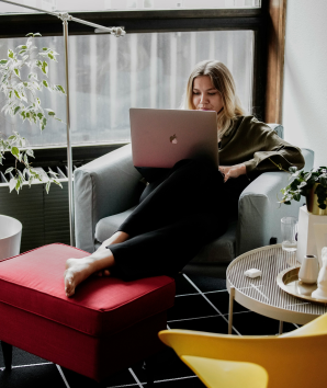Student sits on a chair with a laptop