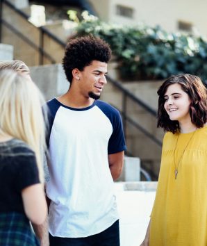 Three students socialise within a university