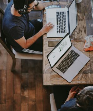 Student with headphones on whilst on a laptop
